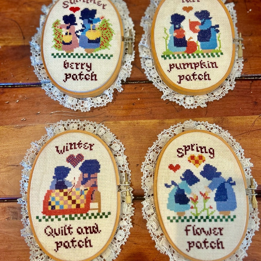 Vintage Paragon wood-framed cross-stitch pieces representing the four seasons.